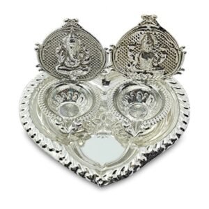 silver puja thali with lord ganesha and lakshmi